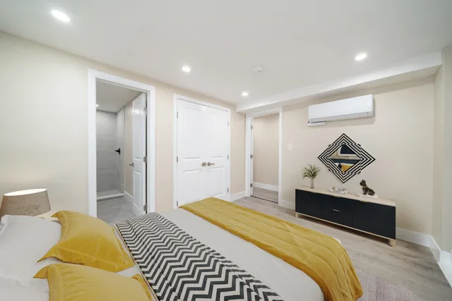 a bedroom with a bed and a painting on the wall