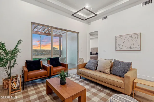 a living room with furniture and a large window