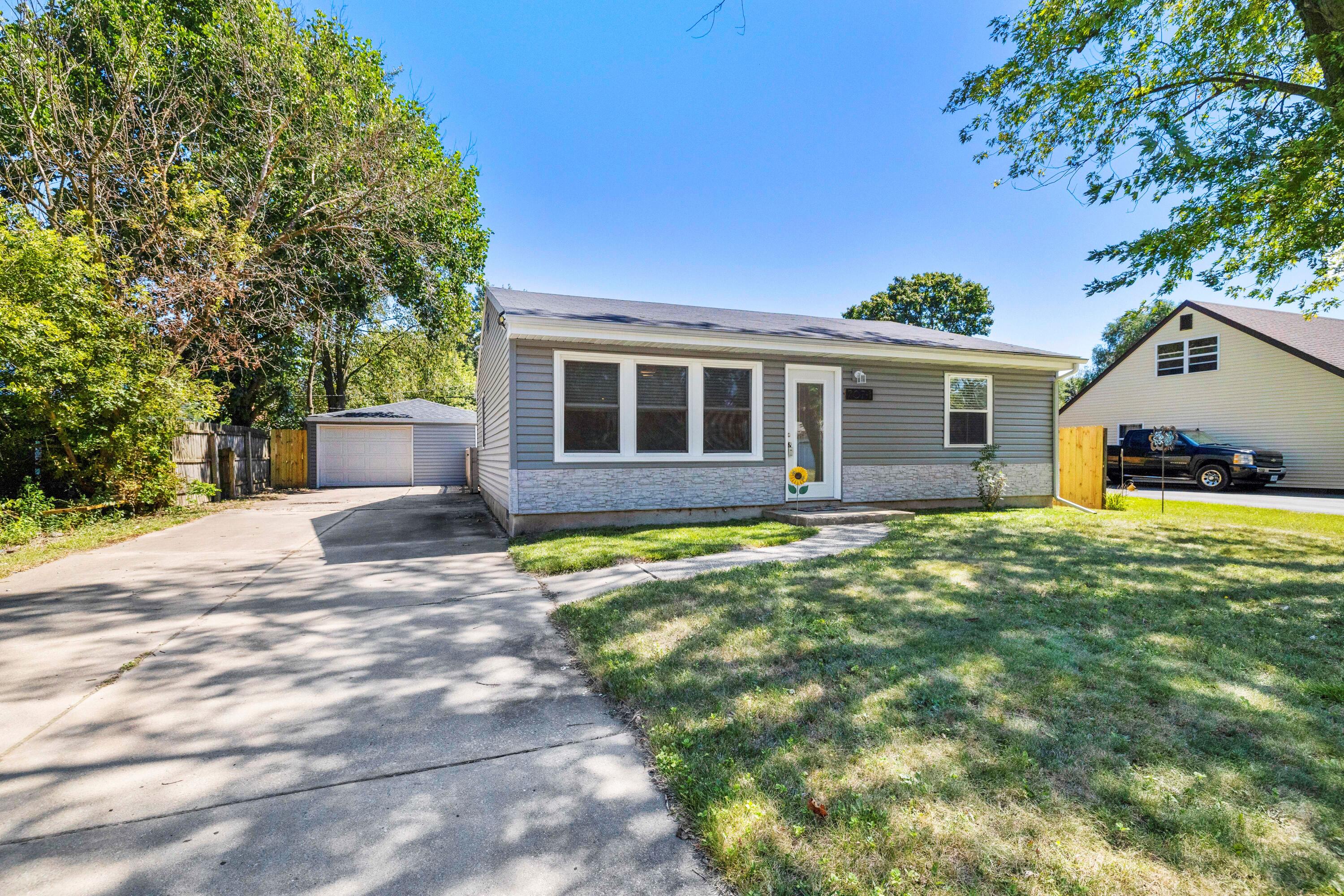 707-1 Imperial Road Valparaiso, IN 46385 - Photo 1 of 17 a front view of a house with a yard and garage