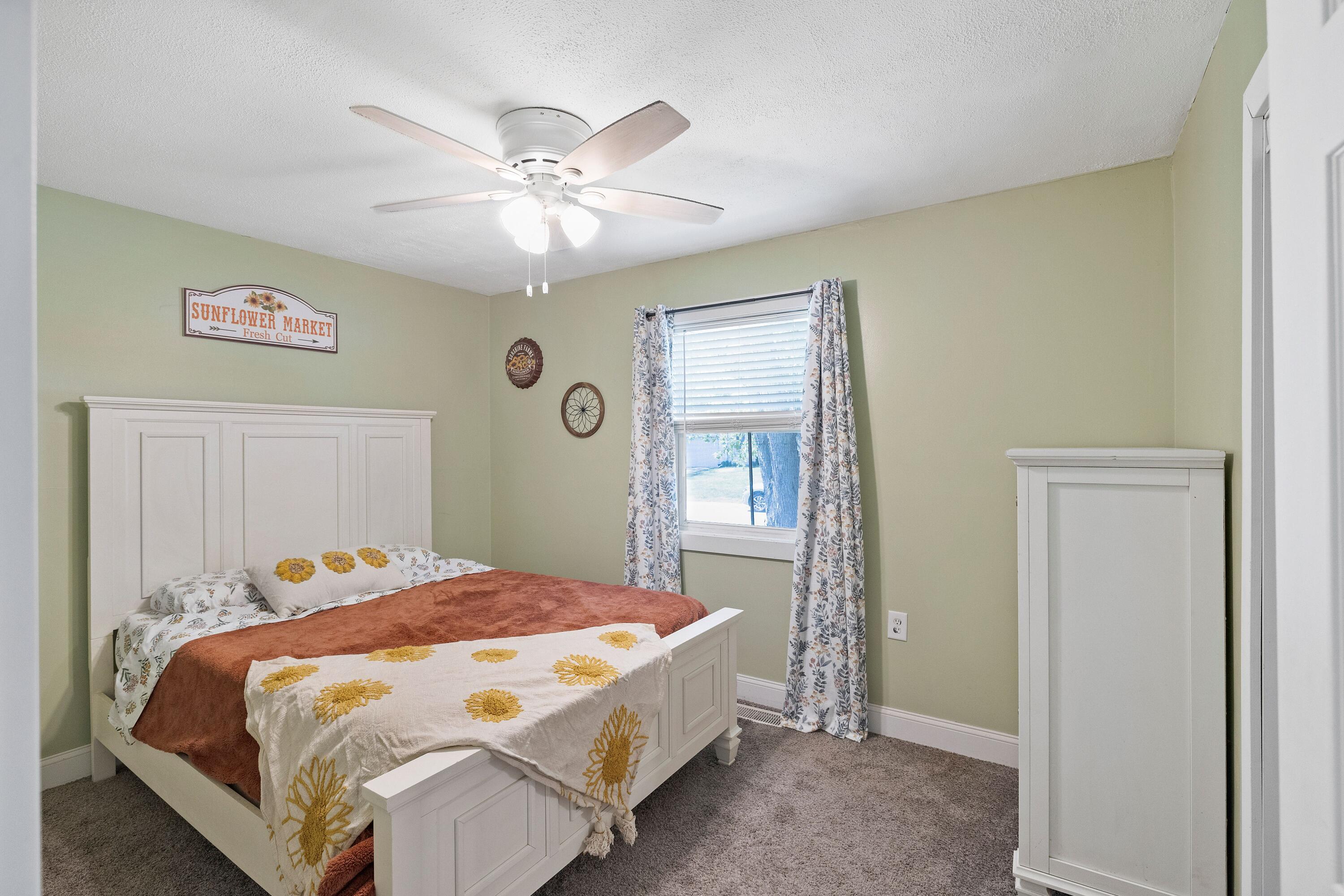 707-1 Imperial Road Valparaiso, IN 46385 - Photo 12 of 17 a bedroom with a bed and a chandelier