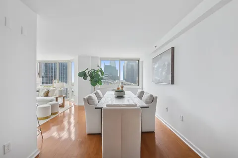 a dining room with furniture and wooden floor