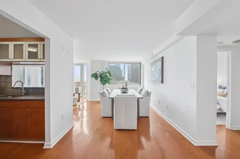 a view of a living room and kitchen with a sink