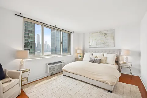 a bedroom with a large bed and a large window