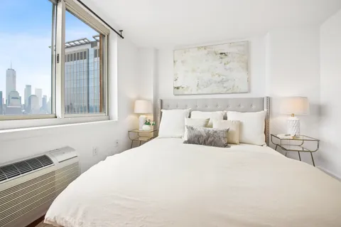 a bedroom with a large bed and a window