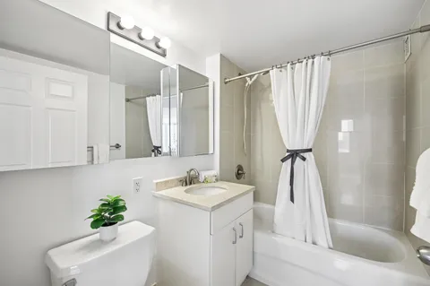 a bathroom with a sink a mirror and a shower curtain