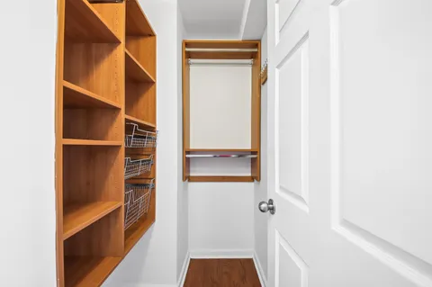 a view of walk in closet with empty racks