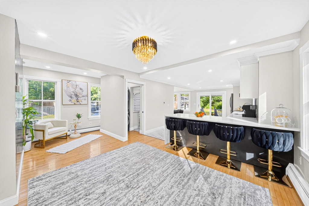 24 Miller Road Wilmington, MA 01887 - Photo 9 of 40 a living room with furniture a wooden floor and a table