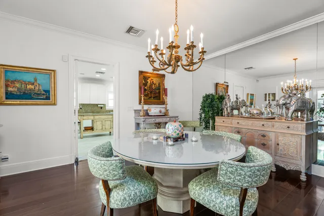 a view of a dining room with furniture and chandelier