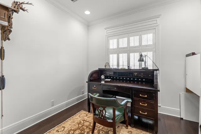 a view of a workspace room with wooden floor windows