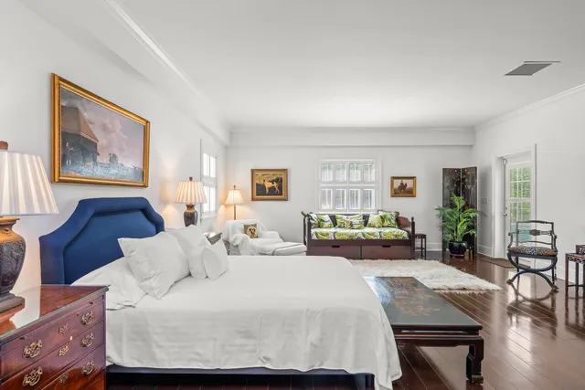 a bedroom with a large bed and a couch