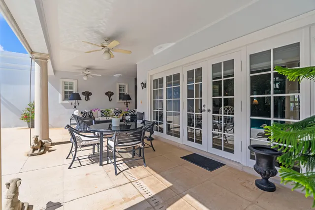 a view of a dining room and livingroom with furniture and floor to ceiling window