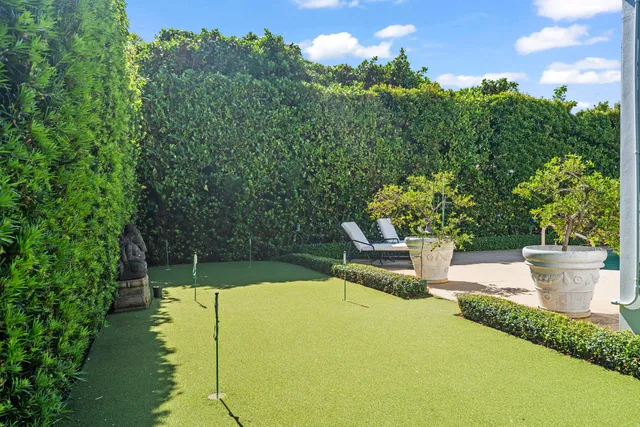 a view of a swimming pool with a patio and garden