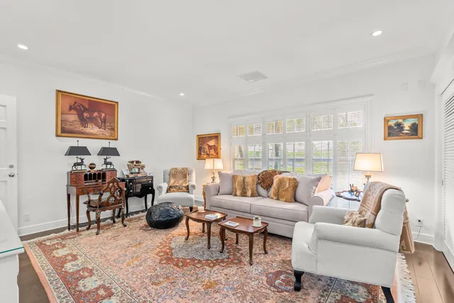 a living room with furniture a rug and a large window