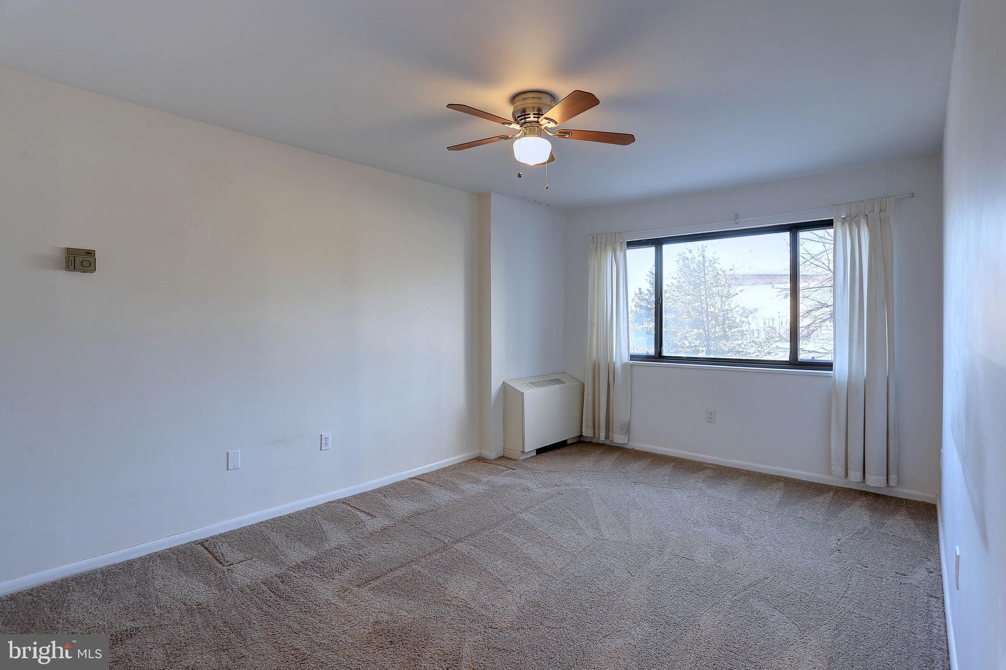 8830 Piney Branch Road, Unit 208 Silver Spring, MD 20903 - Photo 17 of 25 a view of an empty room with a window