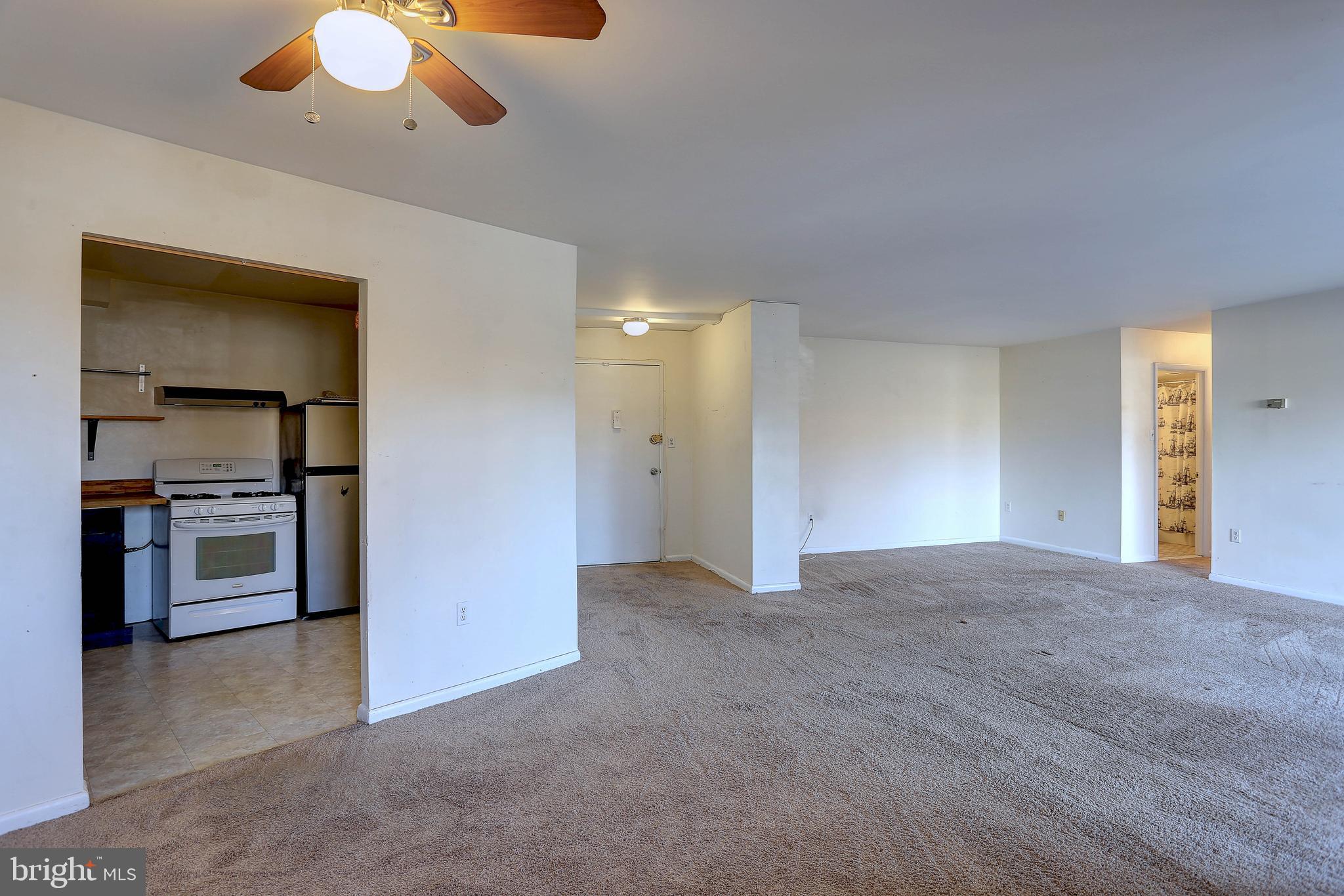 8830 Piney Branch Road, Unit 208 Silver Spring, MD 20903 - Photo 4 of 25 a view of an empty room with a kitchen