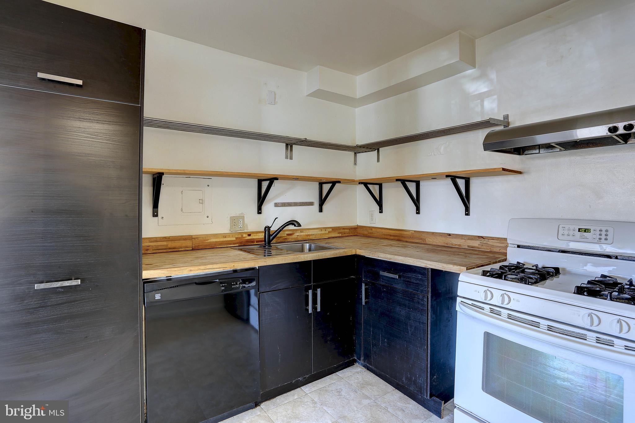 8830 Piney Branch Road, Unit 208 Silver Spring, MD 20903 - Photo 7 of 25 a kitchen with a stove and a sink