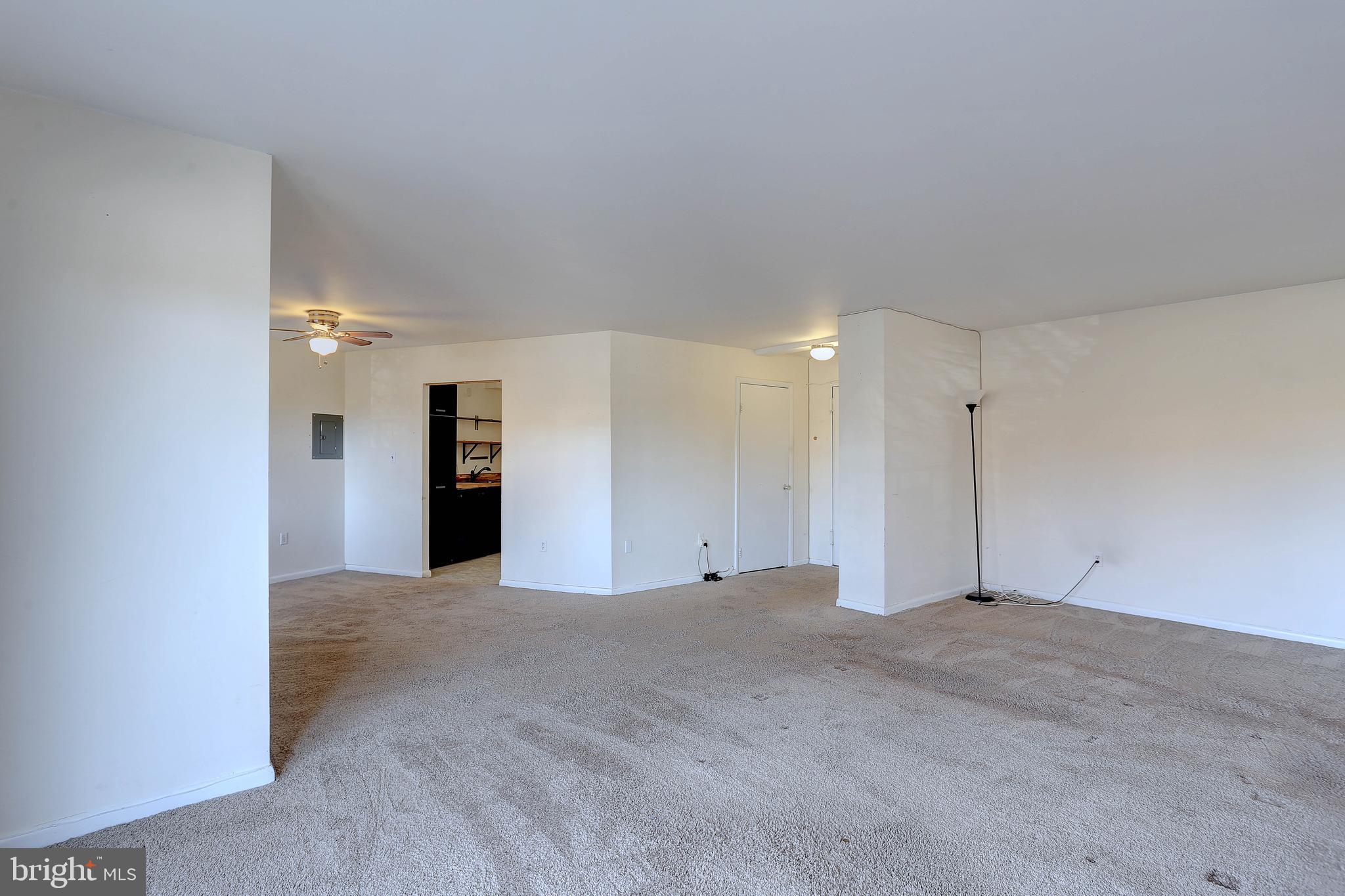 8830 Piney Branch Road, Unit 208 Silver Spring, MD 20903 - Photo 9 of 25 a view of an empty room with a kitchen