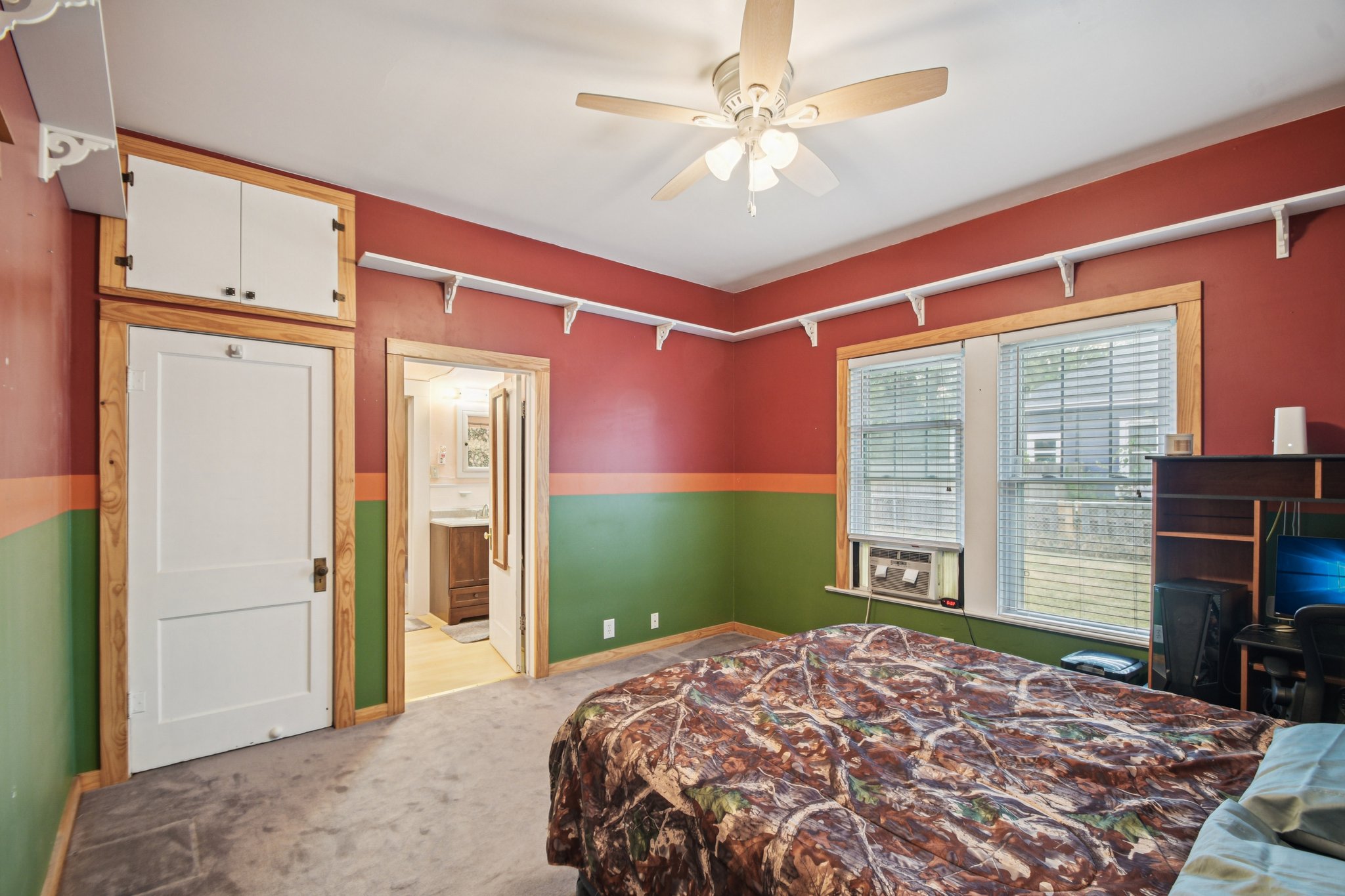 611 North Main Street Elgin, TX 78621 - Photo 16 of 26 a bedroom with a large bed and a flat tv screen