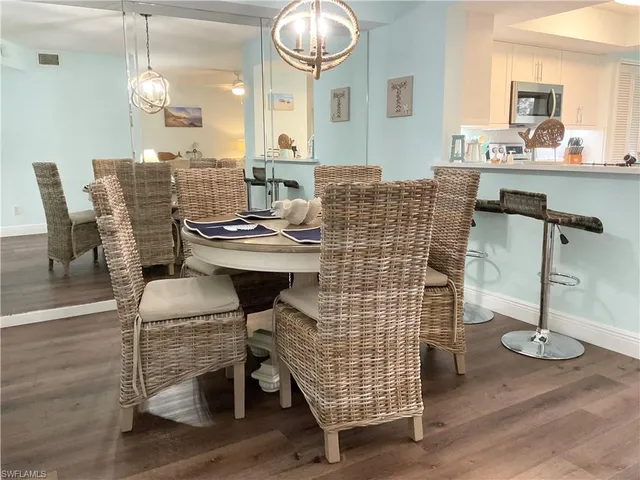 a dining room with furniture and wooden floor