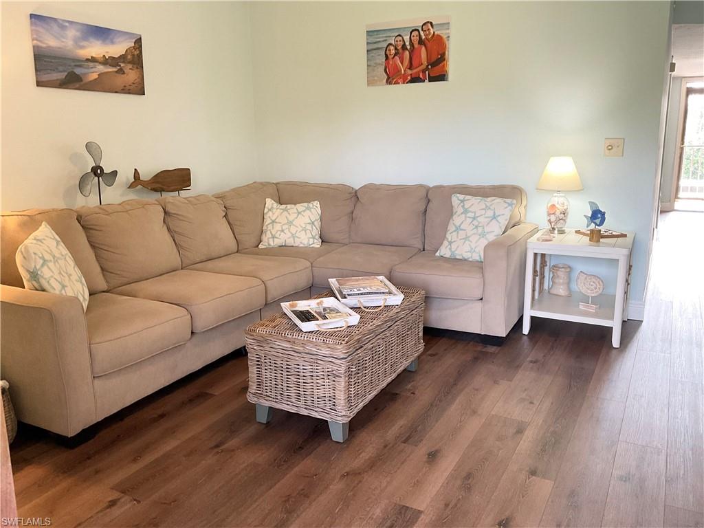 7380 St Ives Way, Unit 1204 Naples, FL 34104 - Photo 13 of 33 a living room with furniture and a wooden floor
