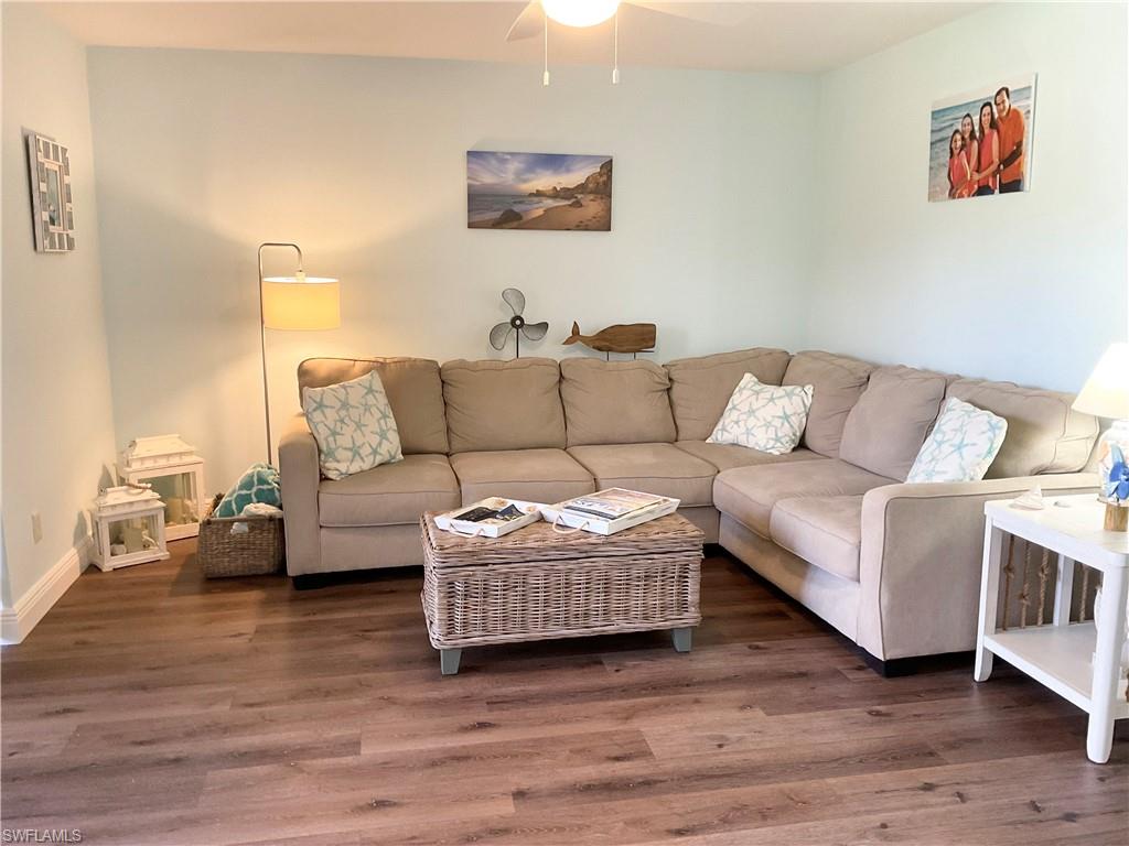 7380 St Ives Way, Unit 1204 Naples, FL 34104 - Photo 14 of 33 a living room with furniture and wooden floor