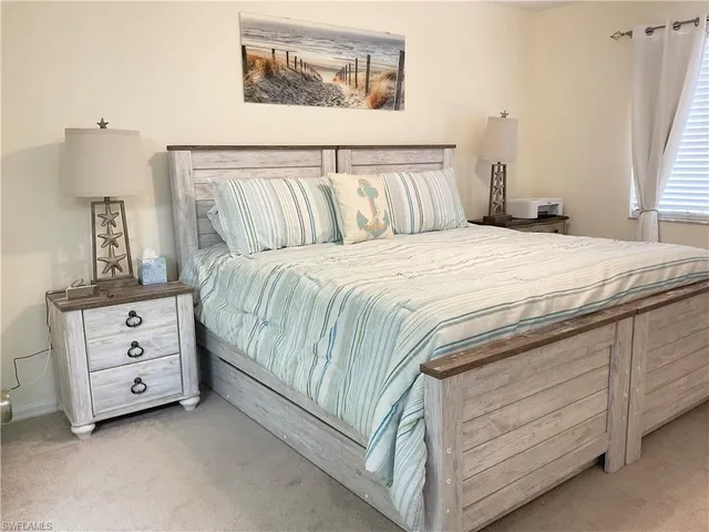 a bedroom with a bed and a night stand