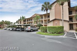 7380 St Ives Way, Unit 1204 Naples, FL 34104 - Photo 2 of 33 a couple of cars parked in front of a house