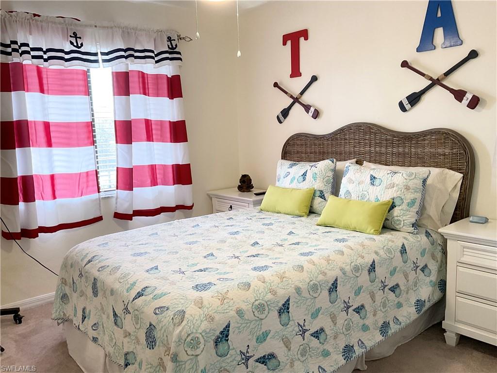 7380 St Ives Way, Unit 1204 Naples, FL 34104 - Photo 21 of 33 a bedroom with a bed and a painting on the wall