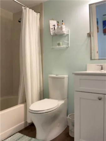 a white toilet sitting next to a bathroom sink