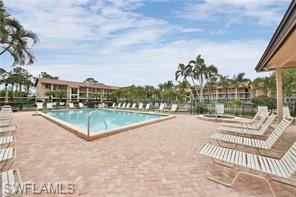 7380 St Ives Way, Unit 1204 Naples, FL 34104 - Photo 25 of 33 a view of a swimming pool with a patio and a yard