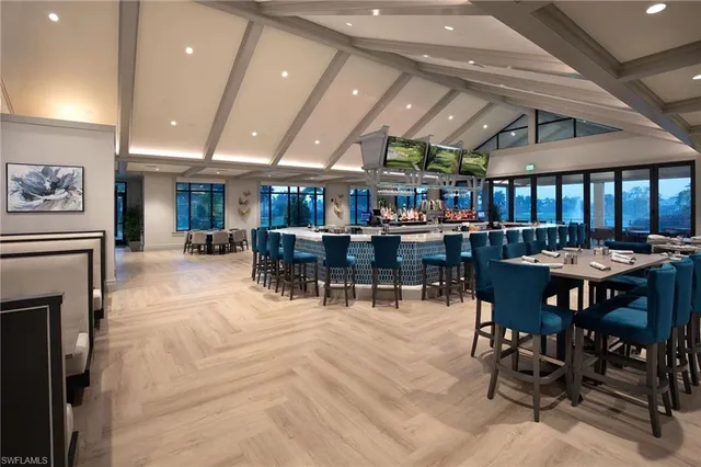 a room with lots of furniture and a large window