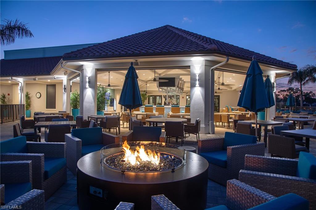 7380 St Ives Way, Unit 1204 Naples, FL 34104 - Photo 33 of 33 a living room with fireplace furniture and a large window