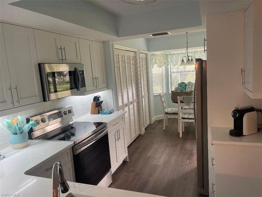 7380 St Ives Way, Unit 1204 Naples, FL 34104 - Photo 6 of 33 a kitchen with a sink stove and cabinets