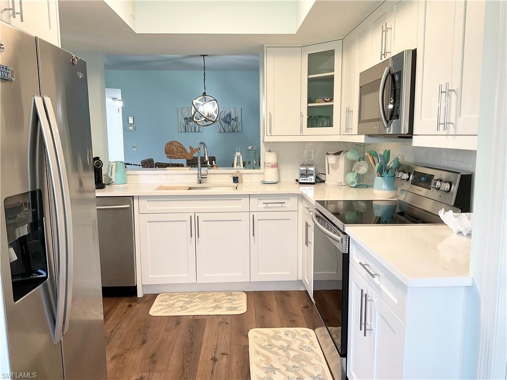 7380 St Ives Way, Unit 1204 Naples, FL 34104 - Photo 7 of 33 a kitchen with a sink stove and refrigerator