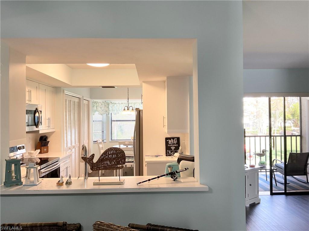 7380 St Ives Way, Unit 1204 Naples, FL 34104 - Photo 9 of 33 a view of a livingroom with furniture wooden floor and bedroom