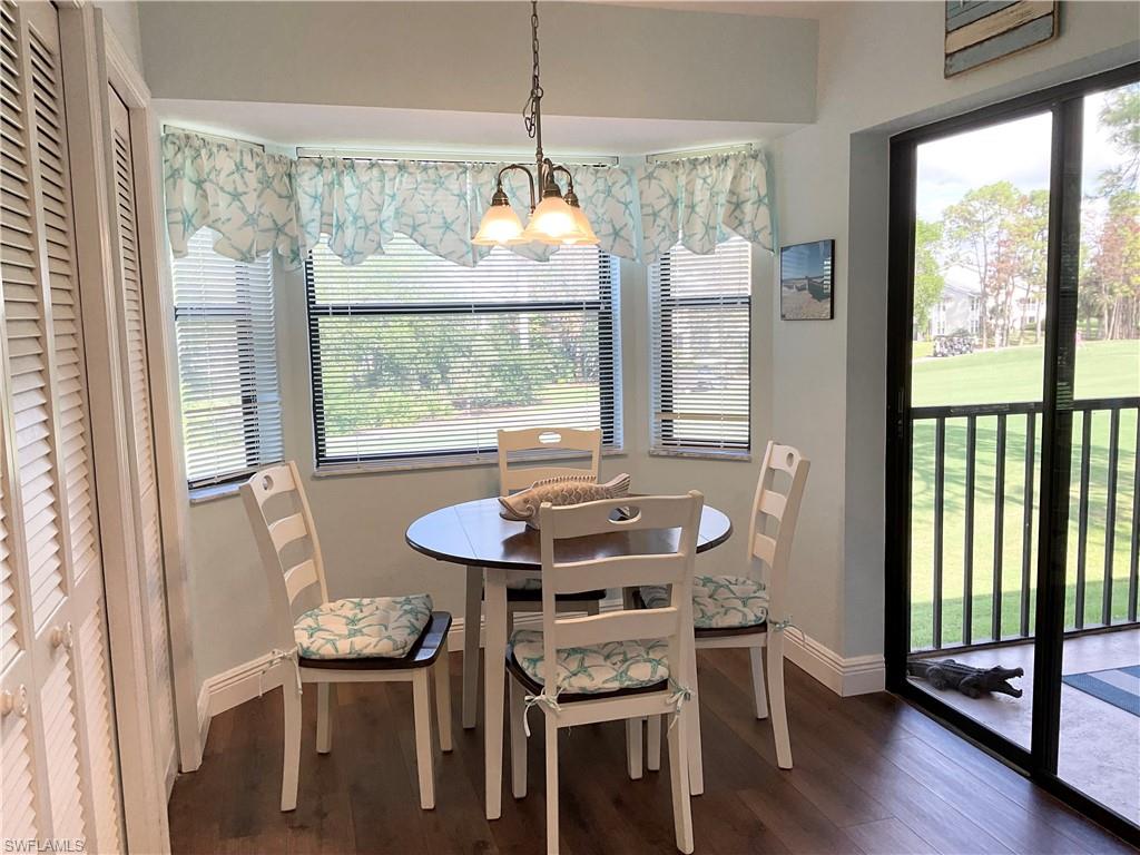 7380 St Ives Way, Unit 1204 Naples, FL 34104 - Photo 10 of 33 a dining room with furniture large windows and wooden floor
