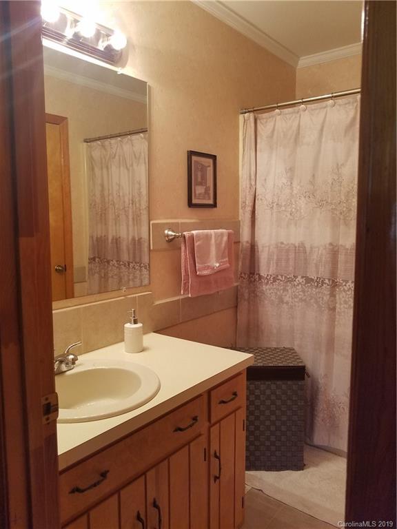 1313 Blacksnake Road Stanley, NC 28164 - Photo 12 of 17 a bathroom with a sink and a mirror