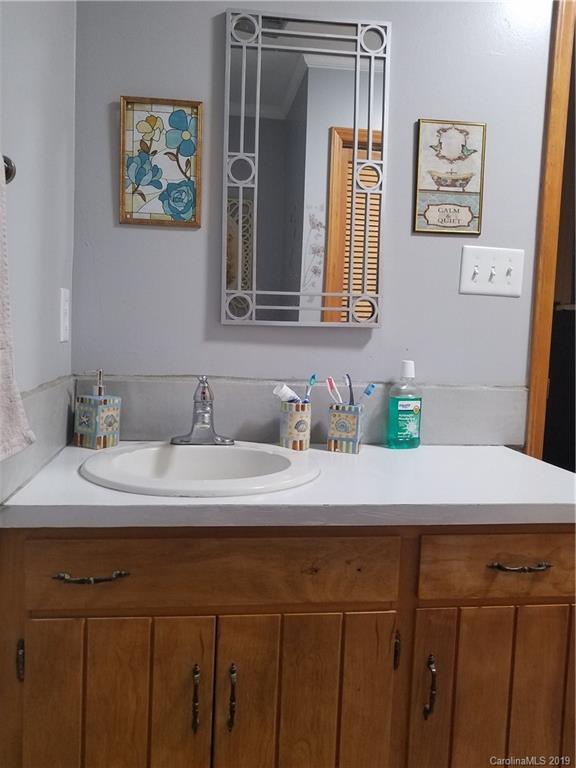 1313 Blacksnake Road Stanley, NC 28164 - Photo 15 of 17 a bathroom with a sink and a mirror