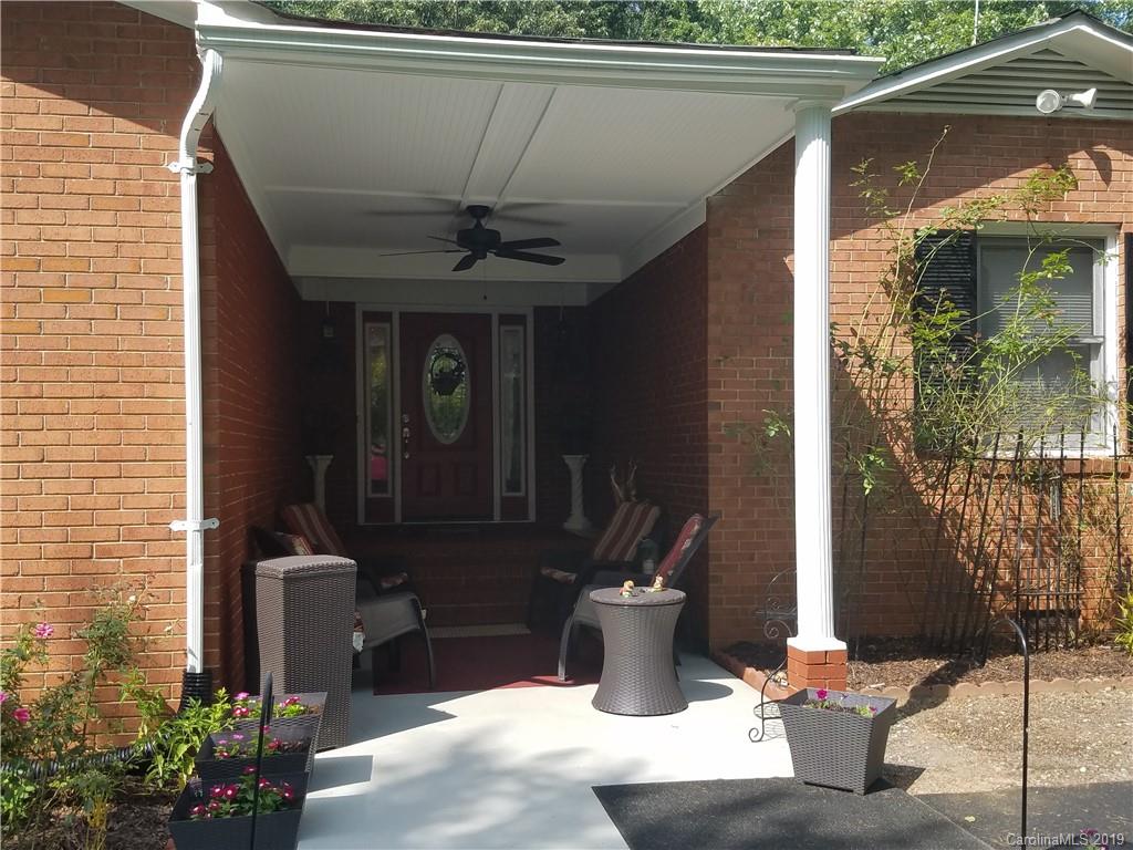 1313 Blacksnake Road Stanley, NC 28164 - Photo 3 of 17 a view of a balcony with table and chairs and potted plants