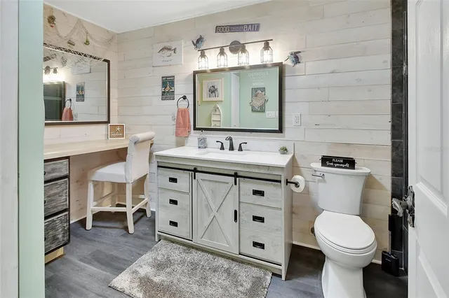 a bathroom with a toilet sink and mirror