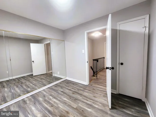 a view of an empty room and wooden floor
