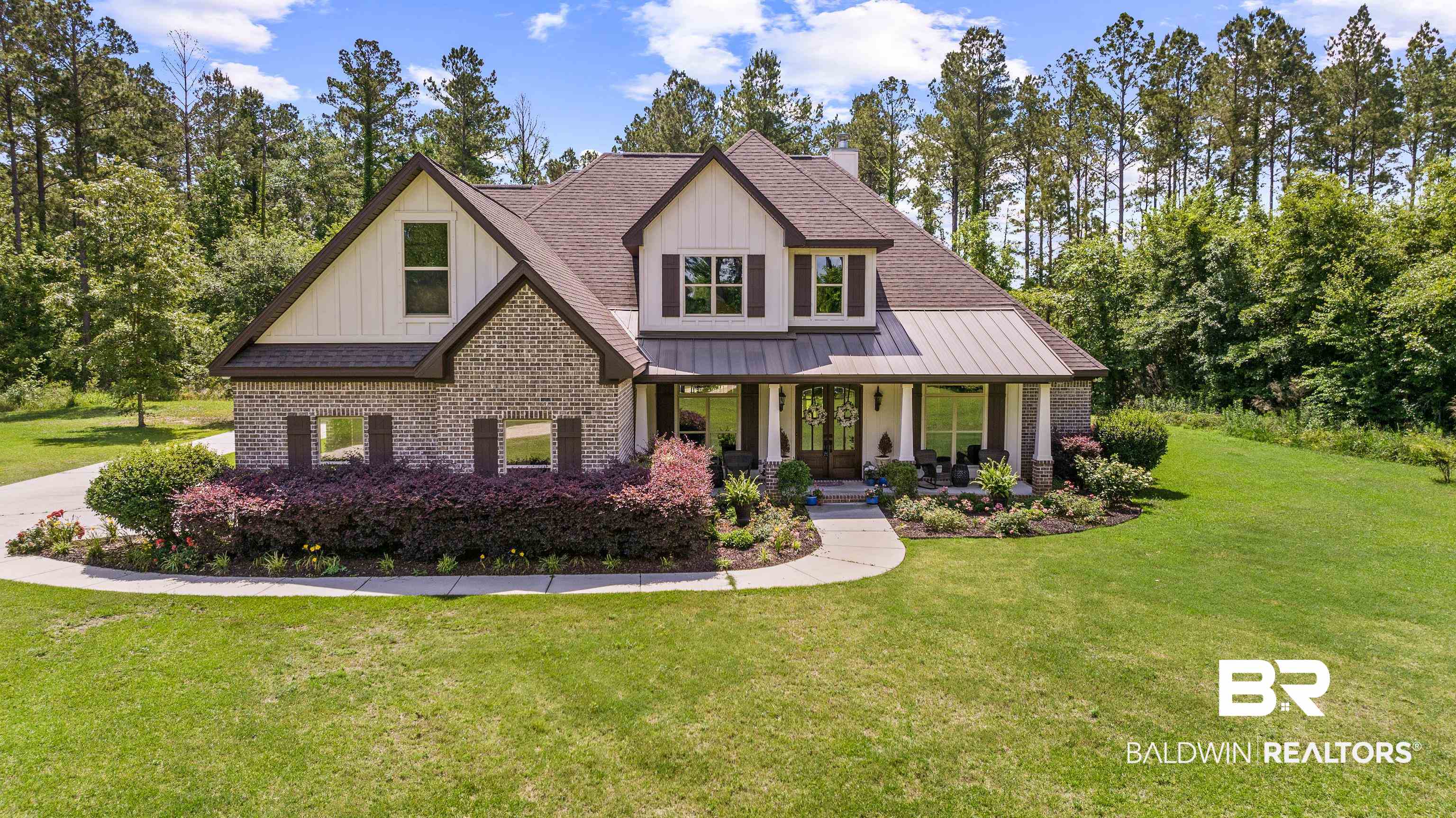 36784 Legacy Way Bay Minette, AL 36507 - Photo 1 of 57 View of front of house featuring brick siding, a front yard, a porch, board and batten siding, and a chimney