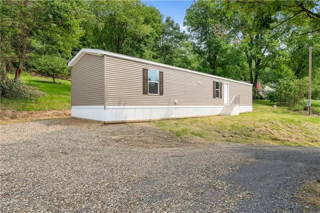 a view of a backyard with large trees