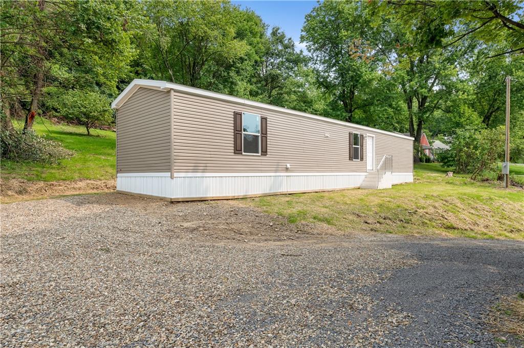a view of a backyard with large trees