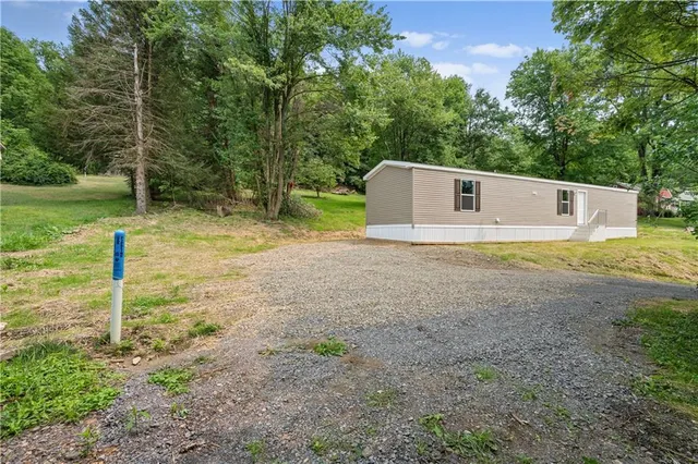 a view of a tiny house with a yard