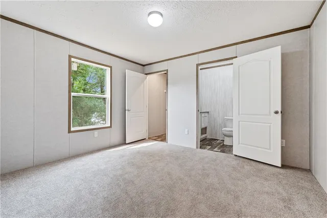 an empty room with windows and closet