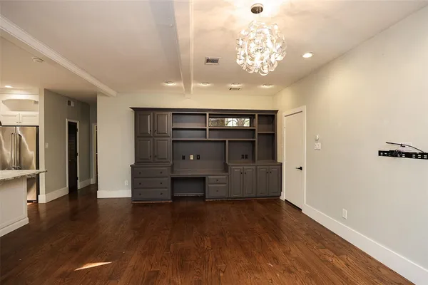 a view of a room with wooden floor and lots of cabinet