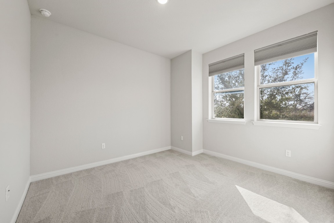 8105 Frida Bend Austin, TX 78744 - Photo 13 of 24 an empty room with windows