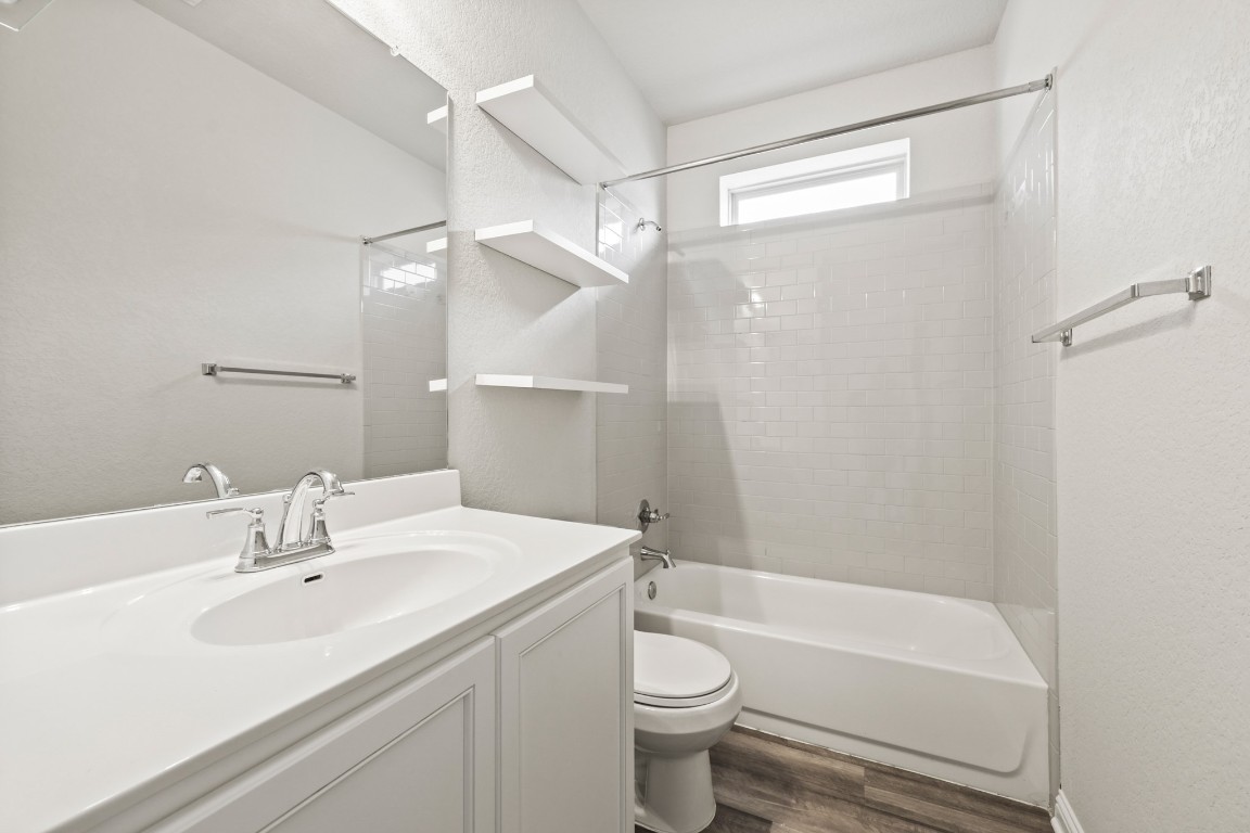 8105 Frida Bend Austin, TX 78744 - Photo 14 of 24 a bathroom with a sink toilet and shower
