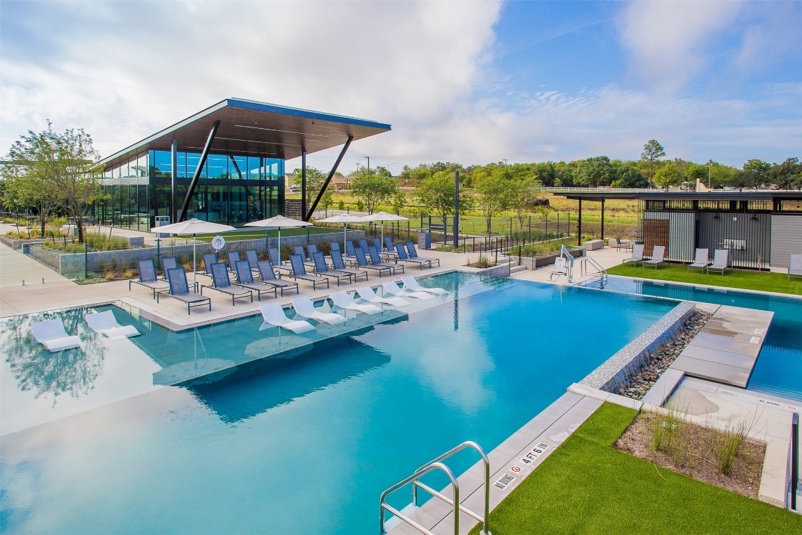 8105 Frida Bend Austin, TX 78744 - Photo 20 of 24 a view of a swimming pool with lounge chairs in the patio